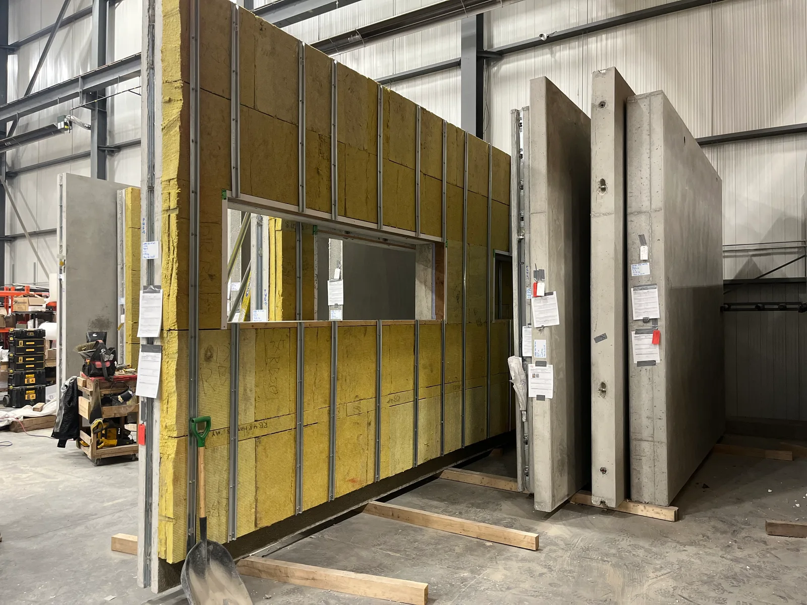 Prefabricated wall panel with a window opening, exposed insulation and edge framing.